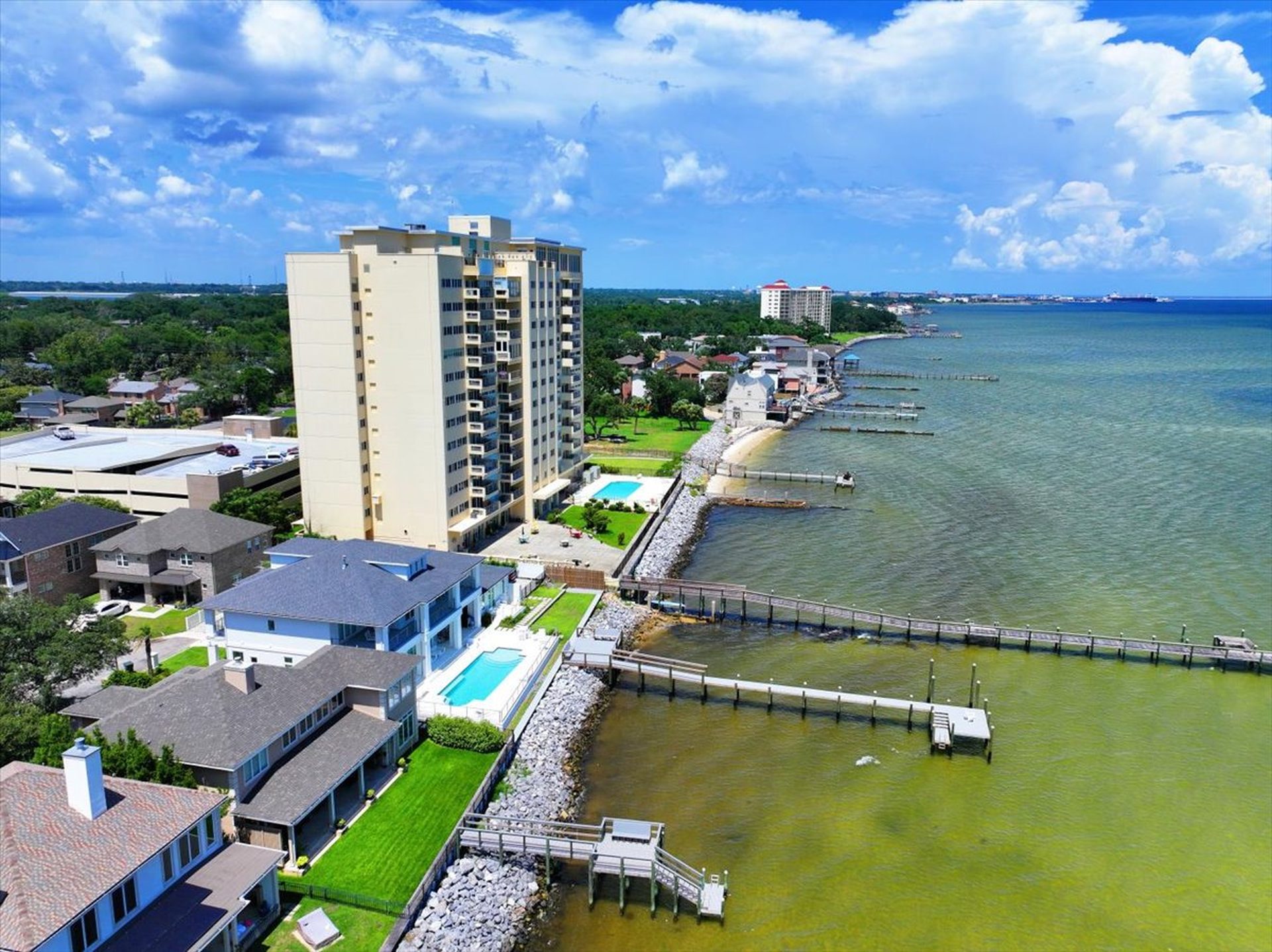 Aerial view of The Bayshore condominium on the shore of Pensacola Bay with its private pier