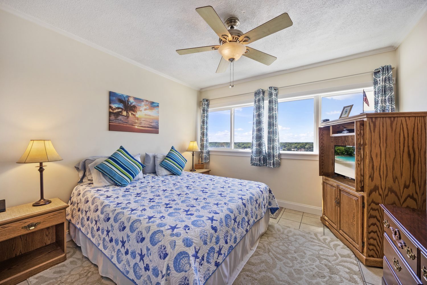 Primary bedroom of Unit 803 with windows overlooking the water